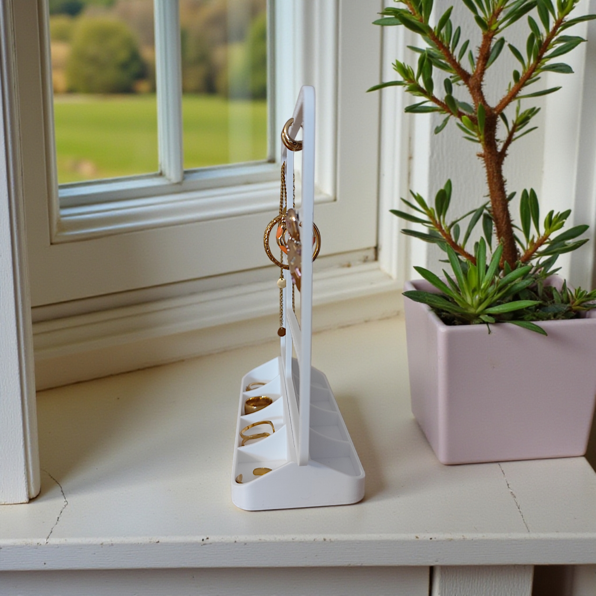 Minimalistisk smyckeshållare med örhängen, ringar och halsband i ren vit design