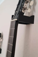 Minimalistiskt väggfäste för gitarr från sidan med ren geometrisk stödkonstruktion