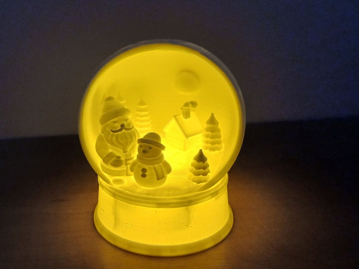 Vinterby i snöglobsform med plats för ett LED-värmeljus