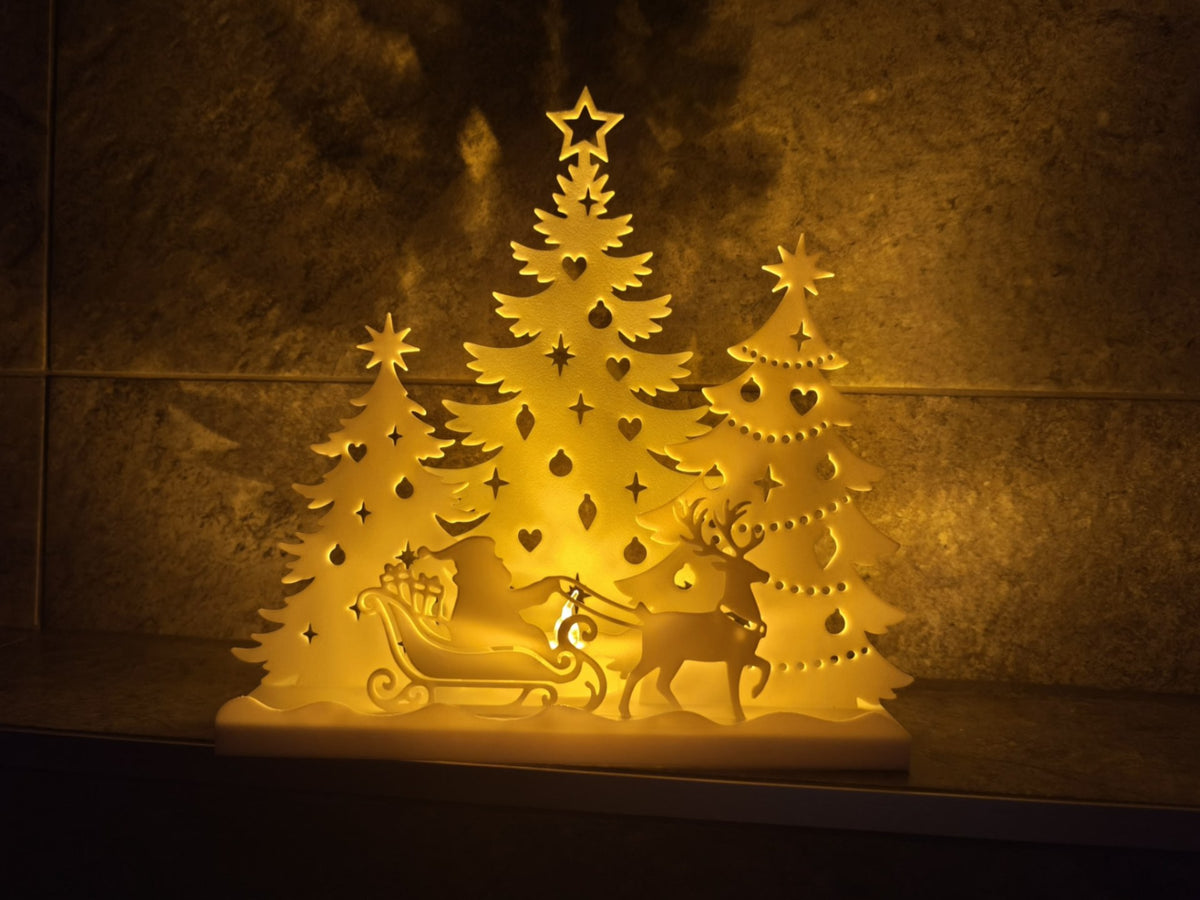 Julhus för värmeljus – jultomte i släde och skog