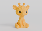 Närbild av en liten stickad girafffigur med virkad textur och uttrycksfulla ögon, ca 8 cm hög
