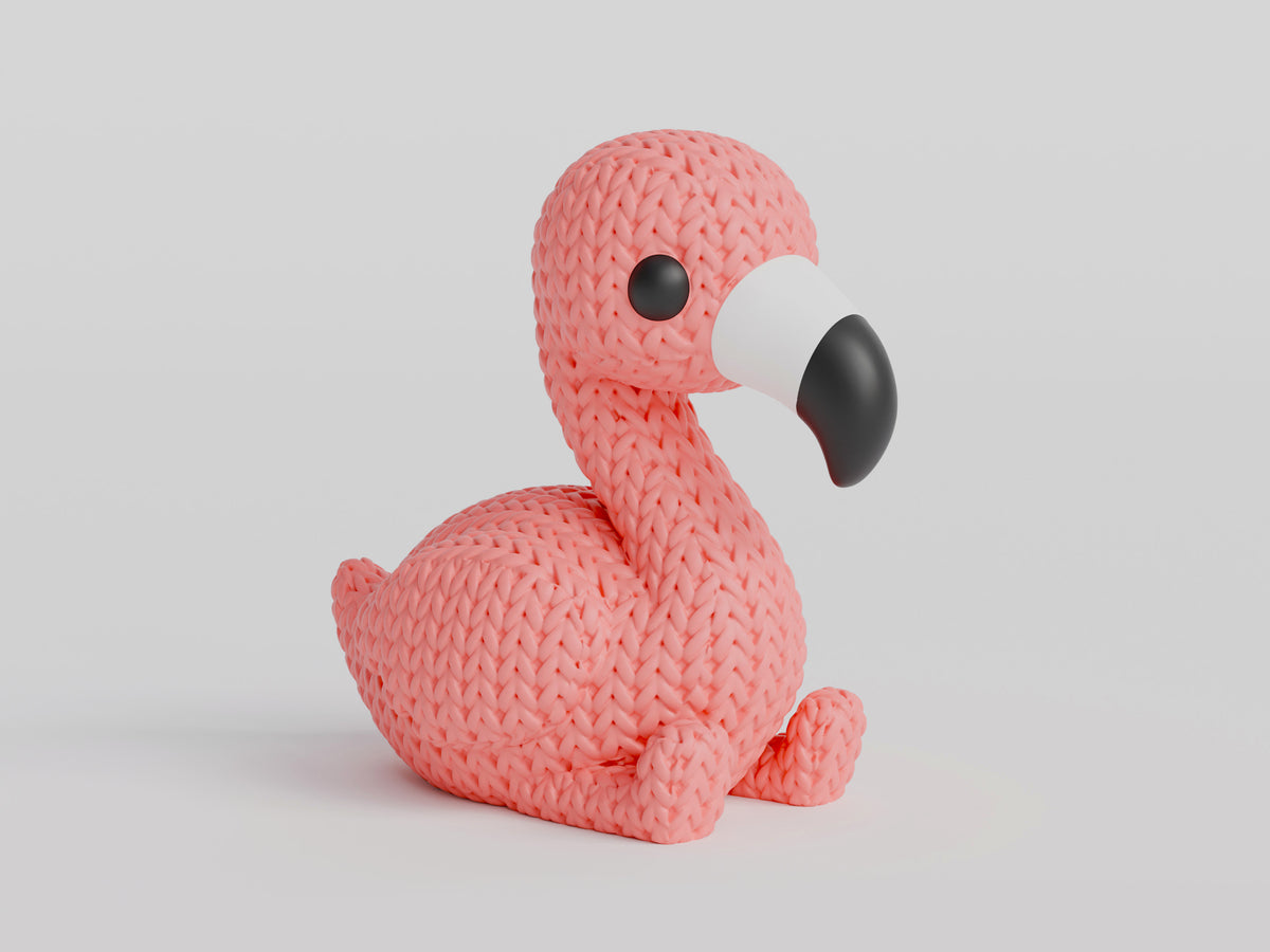 Närbild av en rosa stickad flamingofigur med virkad look, stående upprätt